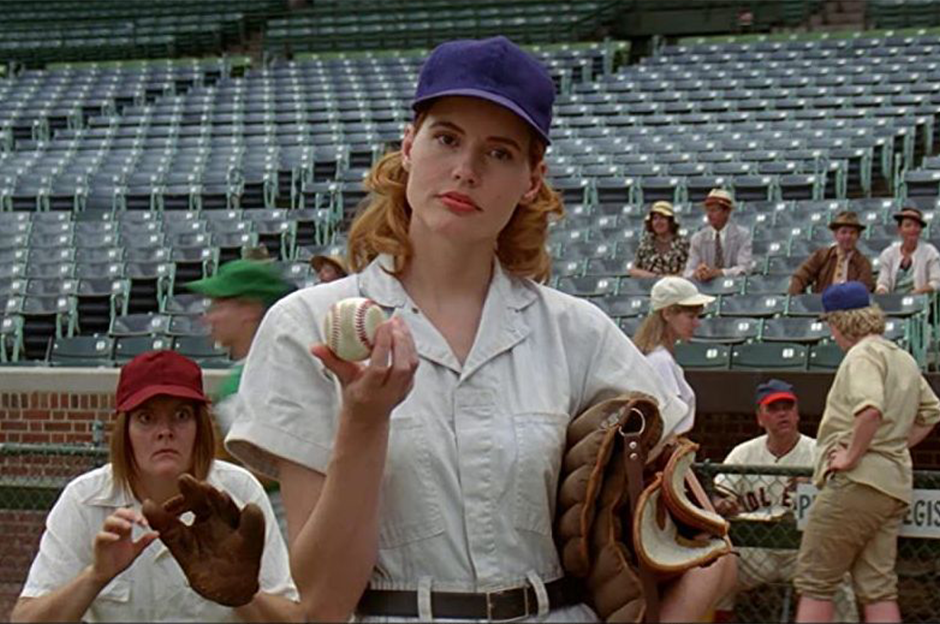 woman holding ball and another woman standing ready to catch ball