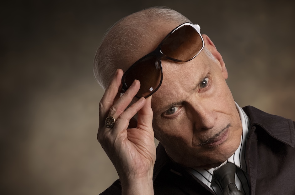 john waters lifting sunglasses off face