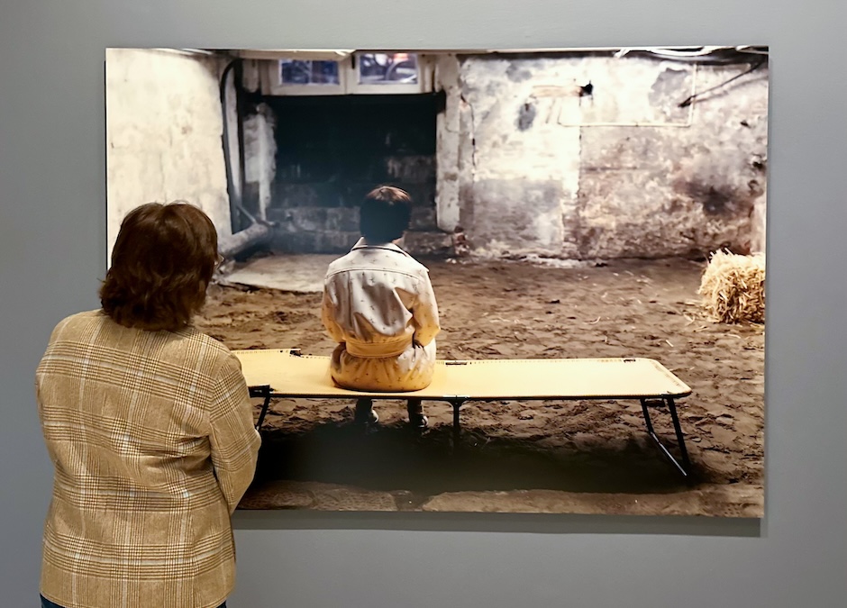 woman looking at a photograph in a gallery