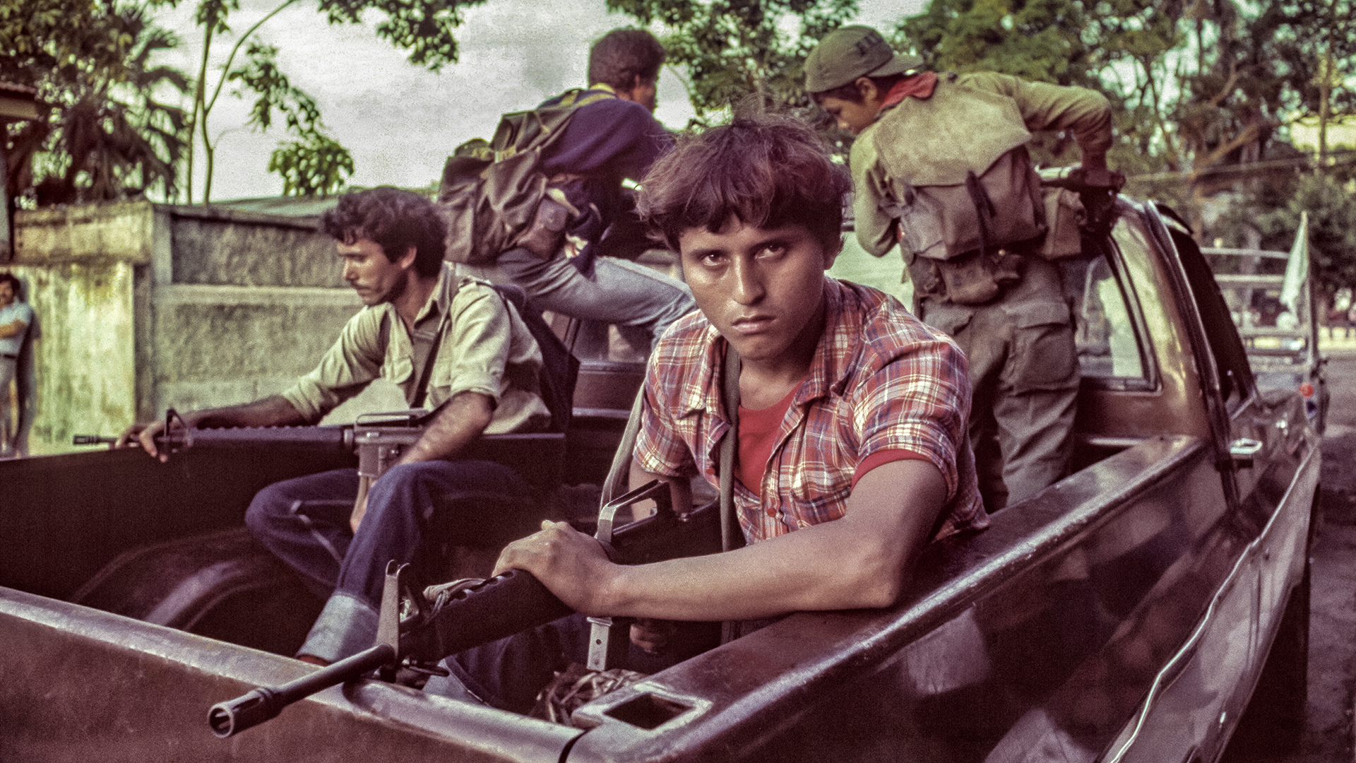 men with guns in a truck