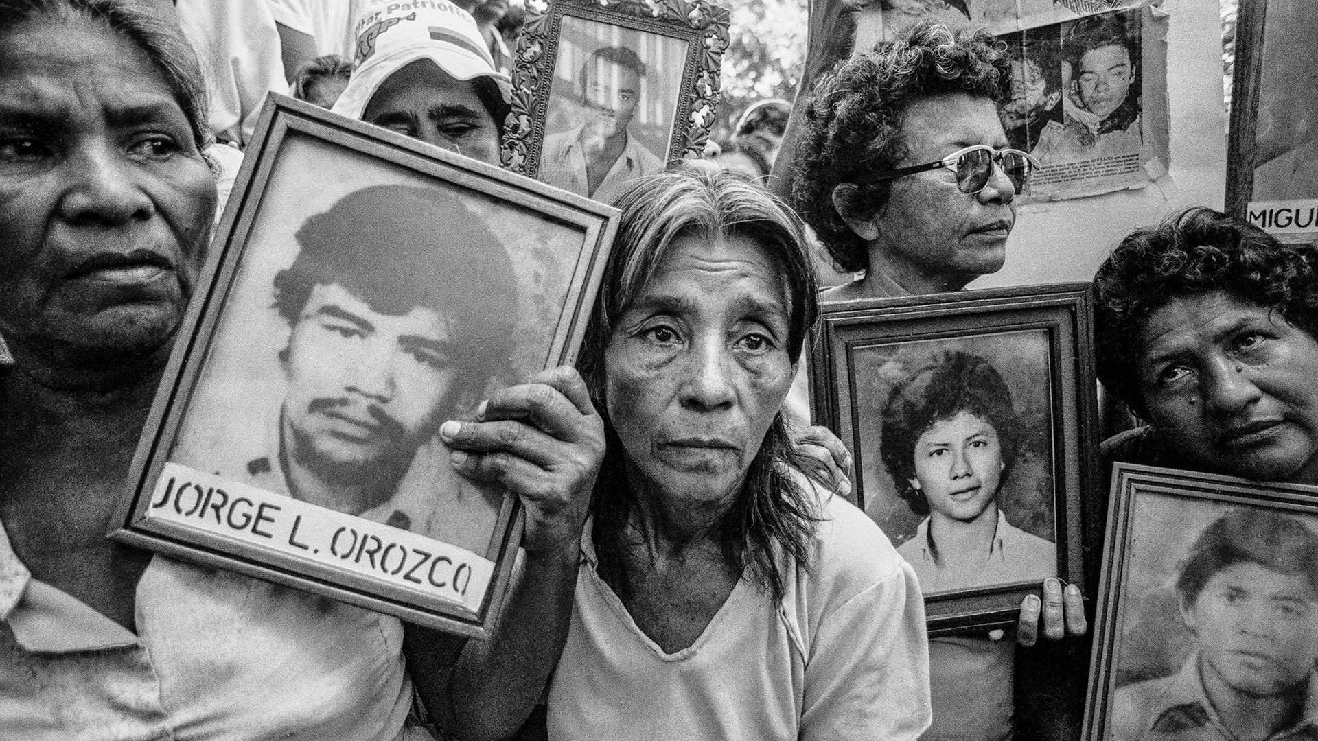 women standing with pictures