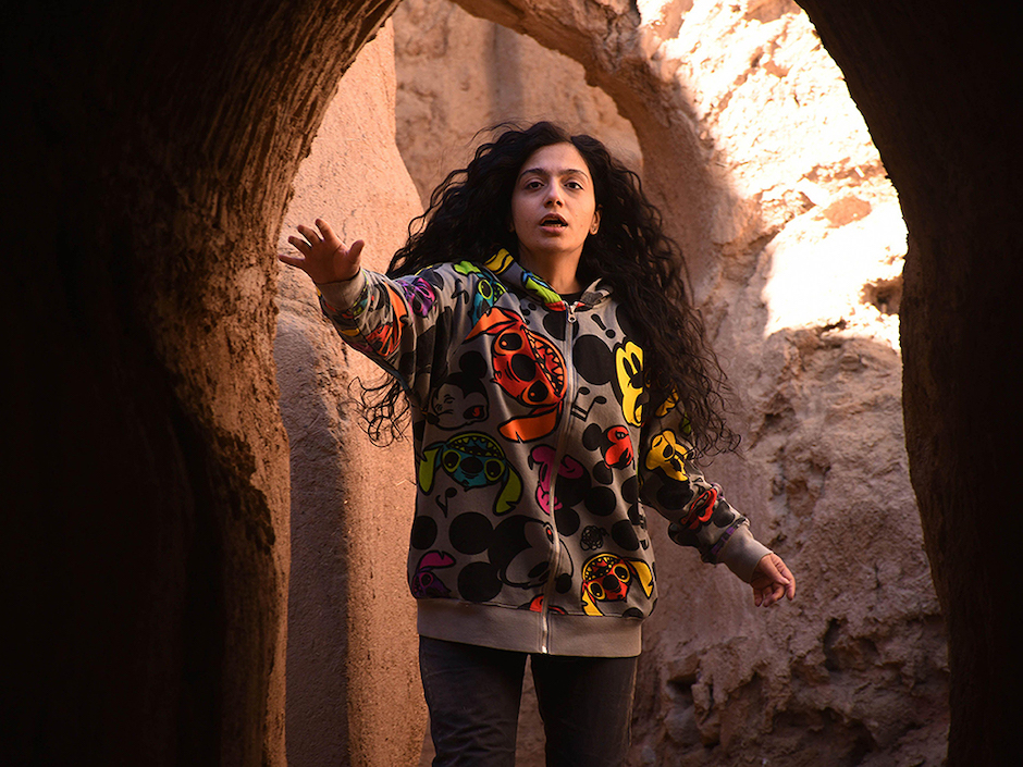 woman reaching forward in cave