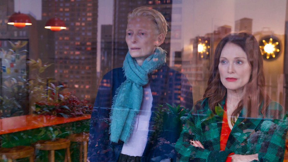 two women looking out a window