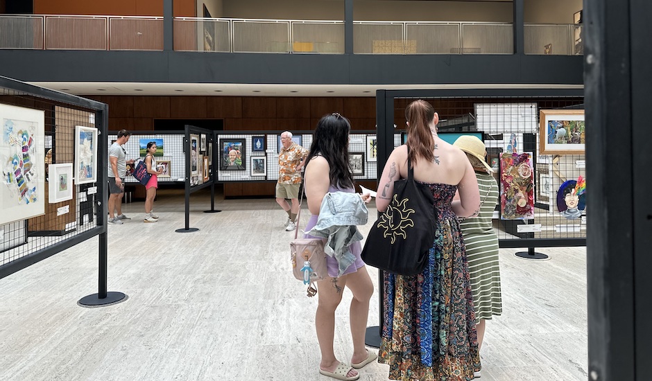 sidewalk show, people observing art in root court